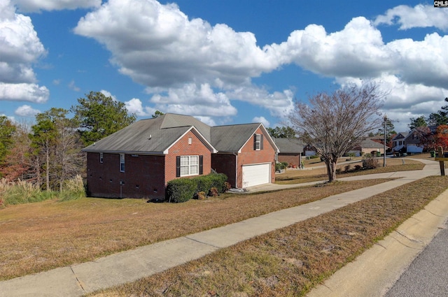 view of side of property featuring a lawn and a garage