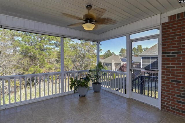 unfurnished sunroom with ceiling fan and wooden ceiling