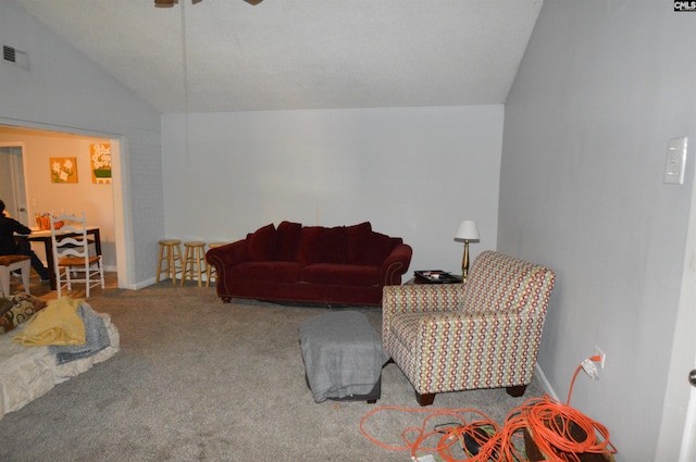 living room with carpet flooring, ceiling fan, and vaulted ceiling