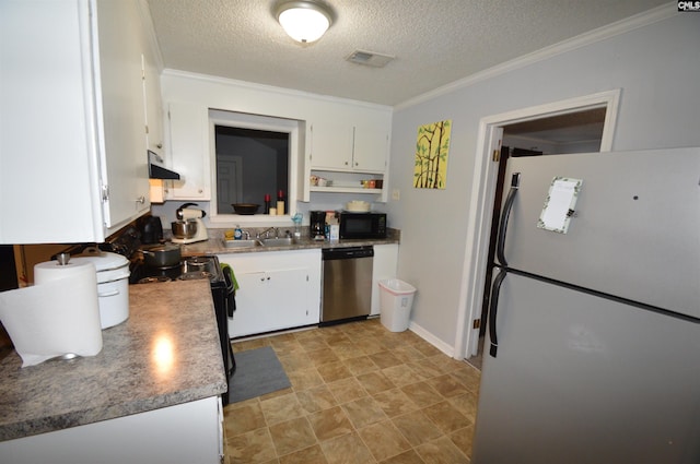 kitchen featuring white cabinetry, white fridge, stainless steel dishwasher, and a textured ceiling