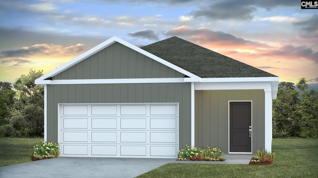 garage at dusk featuring a yard