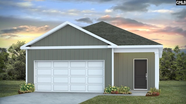 garage at dusk featuring a yard