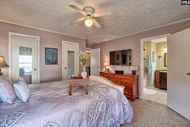 bedroom featuring light carpet, crown molding, ceiling fan, a textured ceiling, and connected bathroom