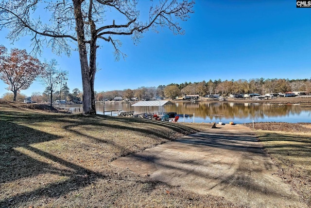 dock area featuring a water view and a lawn