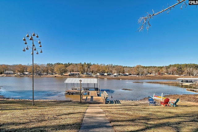 dock area with a yard and a water view