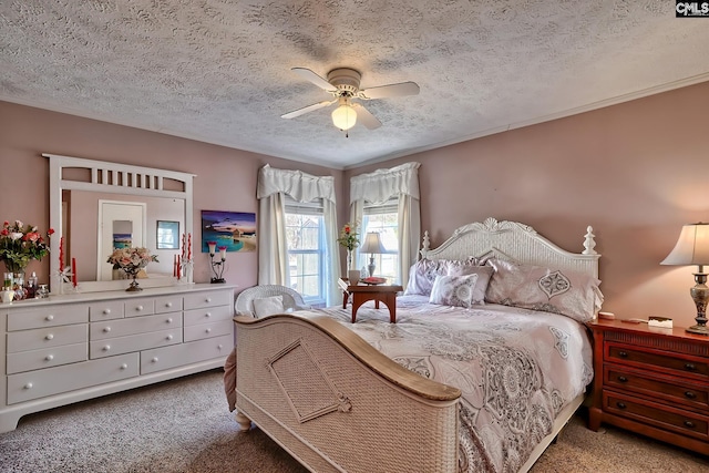 bedroom featuring ceiling fan, carpet floors, and a textured ceiling