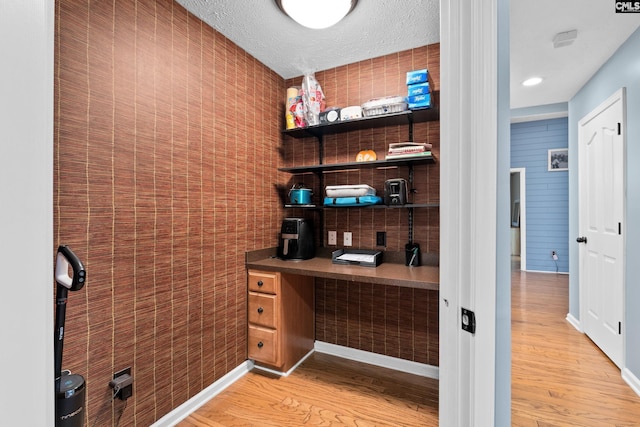 office area with wood-type flooring and a textured ceiling