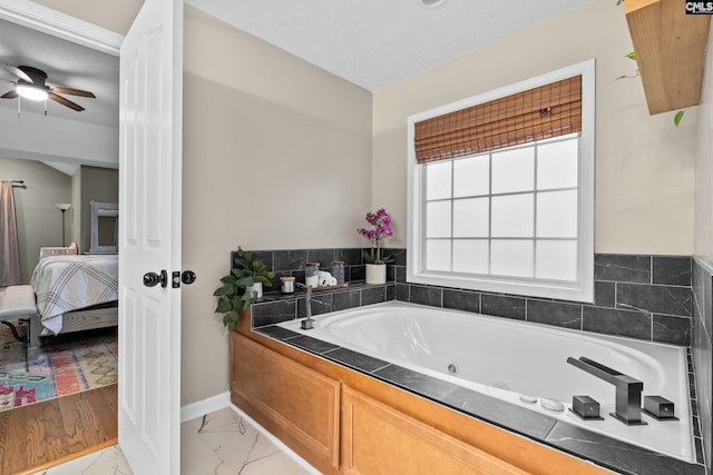 bathroom featuring a bathtub and ceiling fan