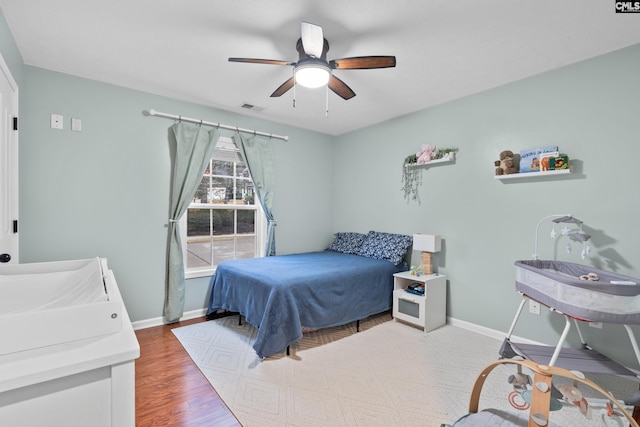 bedroom featuring wood-type flooring and ceiling fan