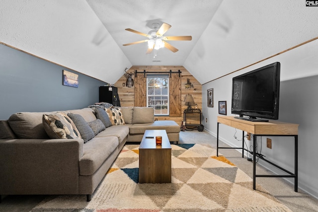 carpeted living room featuring a textured ceiling, wooden walls, ceiling fan, and lofted ceiling