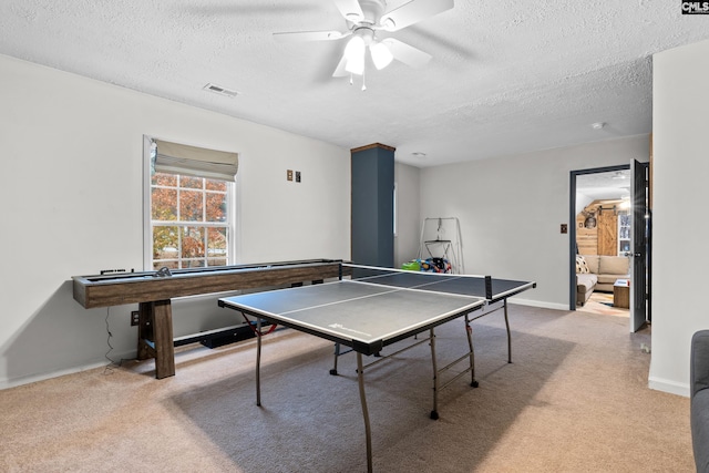 playroom with light carpet, a textured ceiling, and ceiling fan