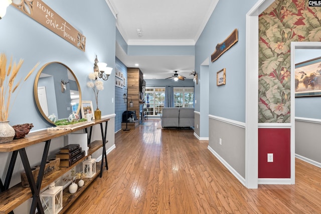 hall featuring light hardwood / wood-style floors and crown molding