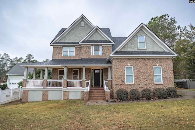 craftsman-style home with covered porch and a front lawn