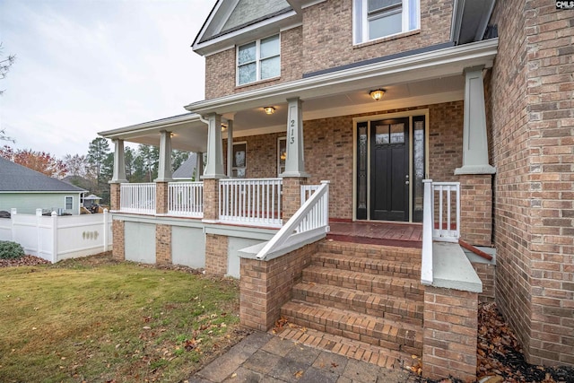 entrance to property featuring a porch