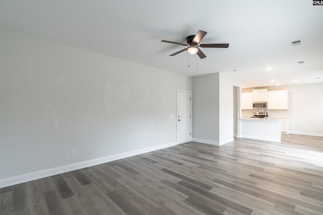 unfurnished living room with ceiling fan and hardwood / wood-style flooring