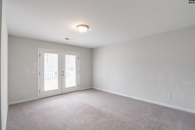 spare room with french doors and carpet floors