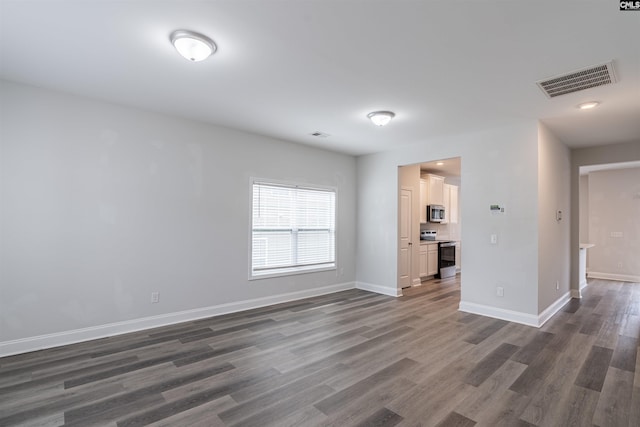 unfurnished living room with dark wood-type flooring