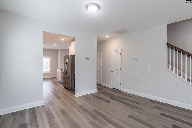 unfurnished living room with wood-type flooring