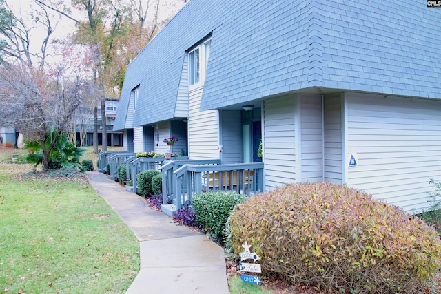 view of property exterior with a yard