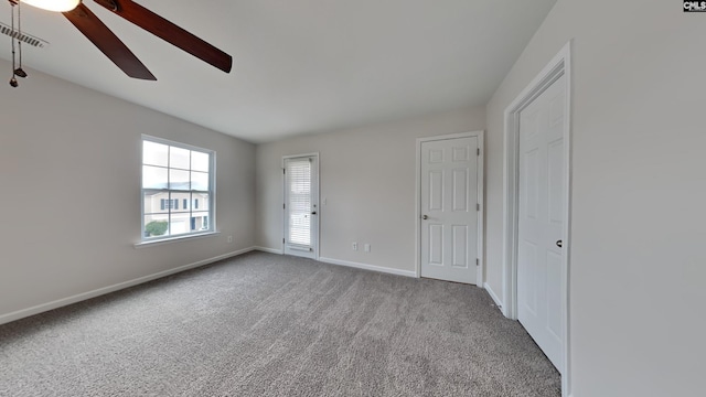 unfurnished room with ceiling fan and light carpet