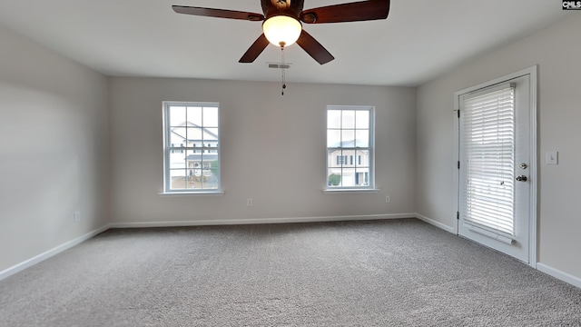 carpeted empty room featuring ceiling fan