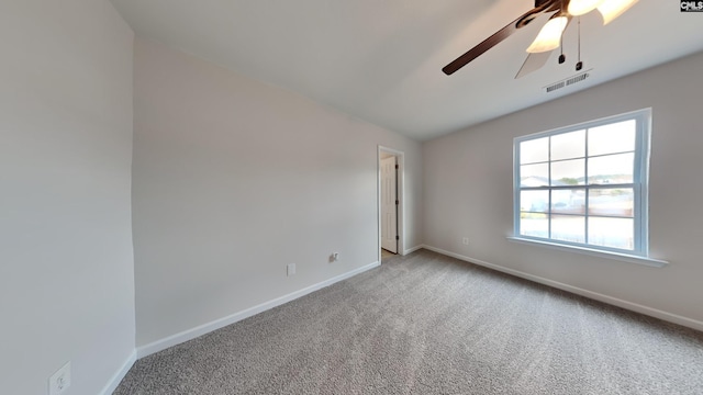 carpeted spare room featuring vaulted ceiling and ceiling fan