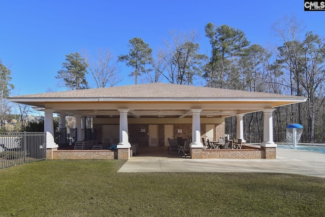 exterior space featuring pool water feature, ceiling fan, a gazebo, a patio, and a lawn