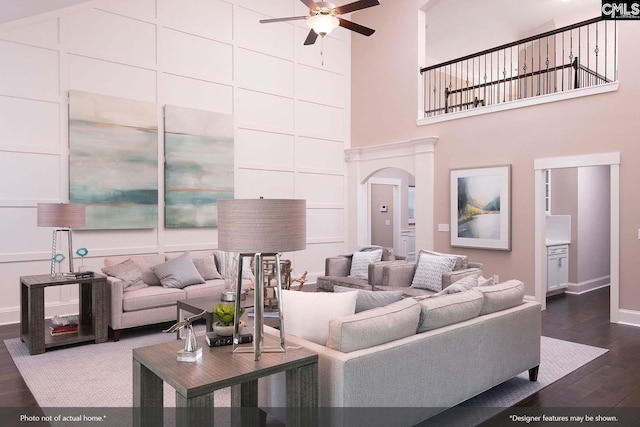 living room featuring dark hardwood / wood-style floors, ceiling fan, and high vaulted ceiling