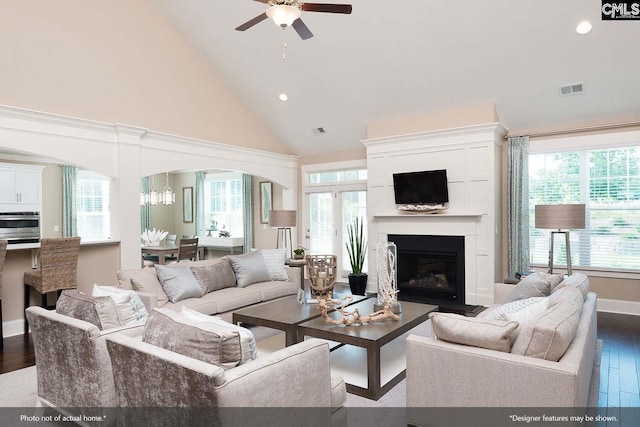 living room with ceiling fan, plenty of natural light, high vaulted ceiling, and dark wood-type flooring