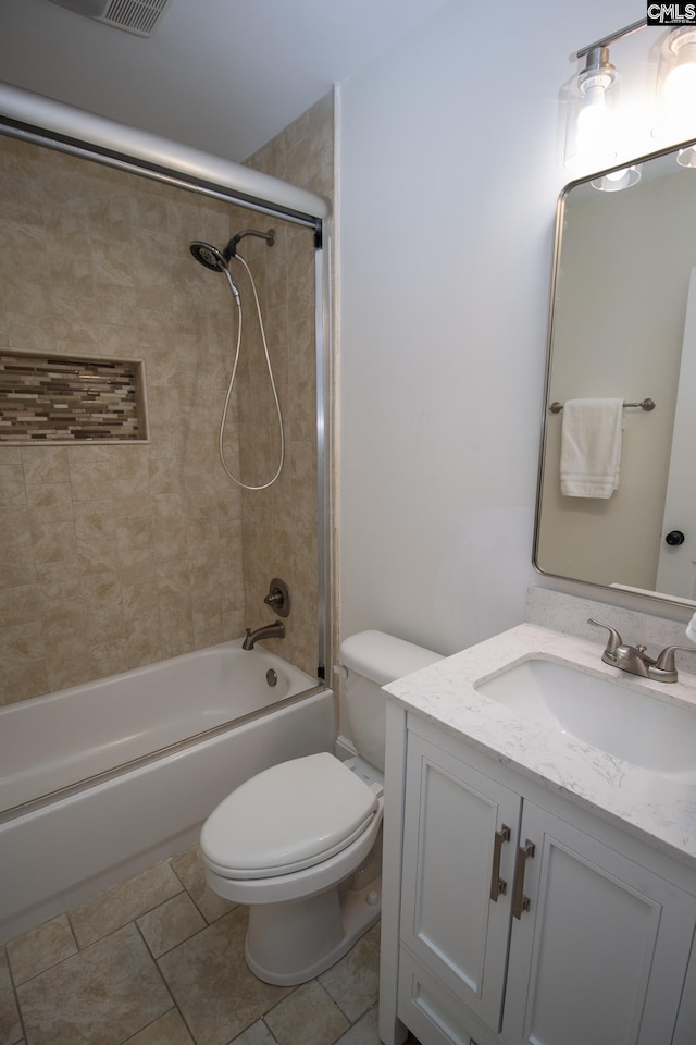 full bathroom with tile patterned floors, vanity, toilet, and tiled shower / bath