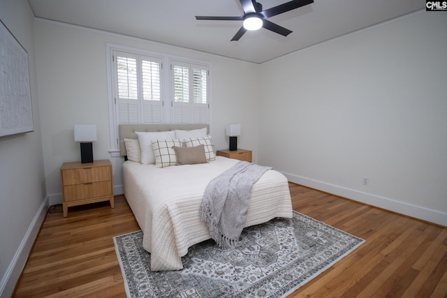 bedroom with ceiling fan and hardwood / wood-style flooring