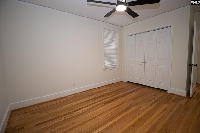 unfurnished bedroom with light wood-type flooring, a closet, and ceiling fan