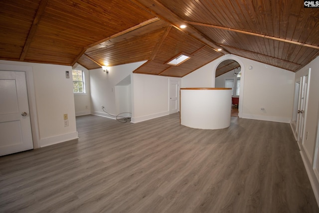 interior space featuring hardwood / wood-style flooring, vaulted ceiling with beams, and wood ceiling