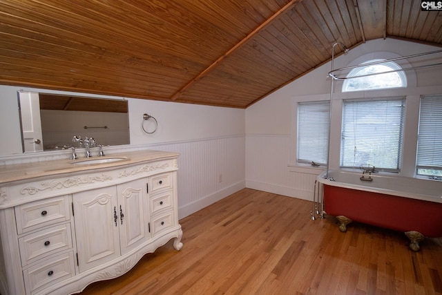 bathroom with hardwood / wood-style floors, a bathtub, wooden ceiling, and lofted ceiling