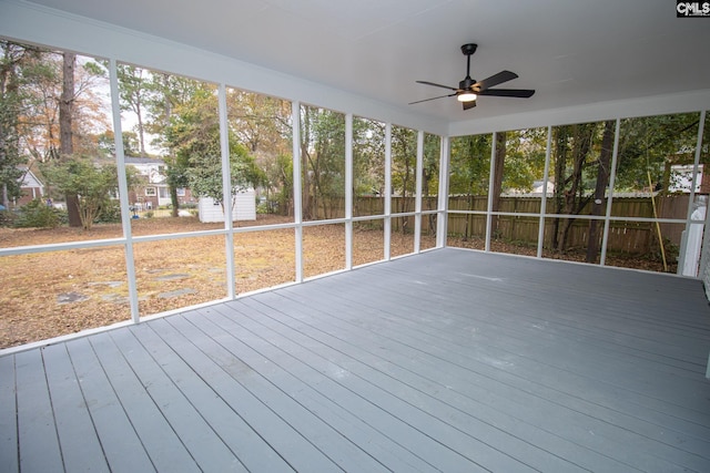 unfurnished sunroom with ceiling fan