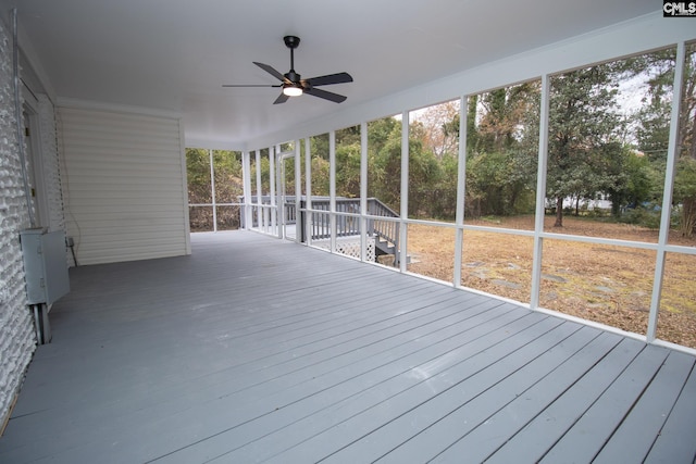 unfurnished sunroom with ceiling fan and a healthy amount of sunlight