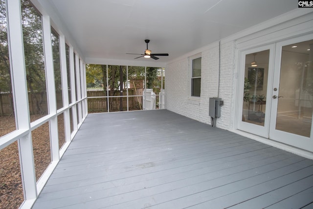 unfurnished sunroom featuring ceiling fan