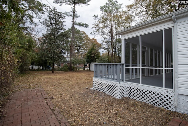 view of yard featuring a sunroom