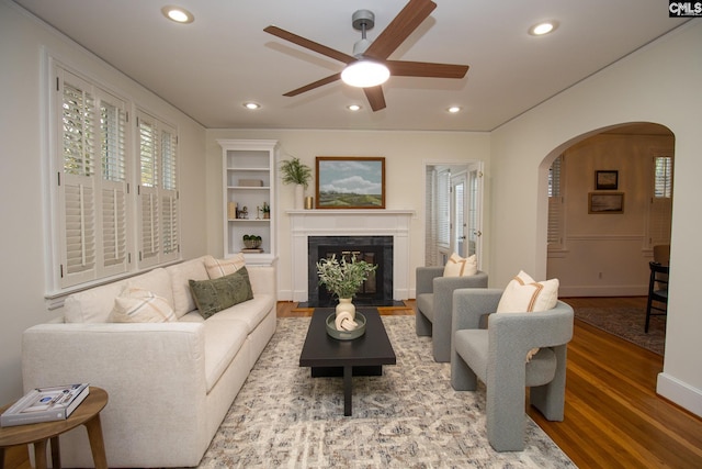 living room with ceiling fan and wood-type flooring