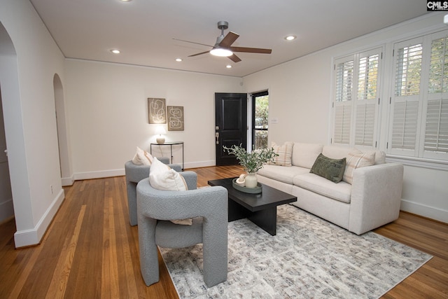 living room featuring hardwood / wood-style flooring and ceiling fan