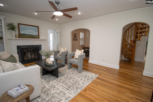 living room with hardwood / wood-style floors and ceiling fan