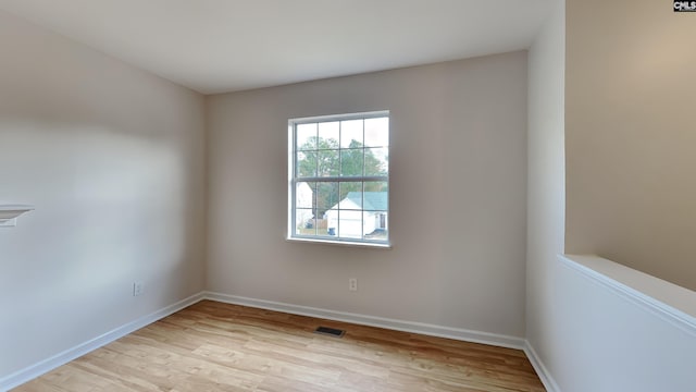 spare room featuring light hardwood / wood-style floors