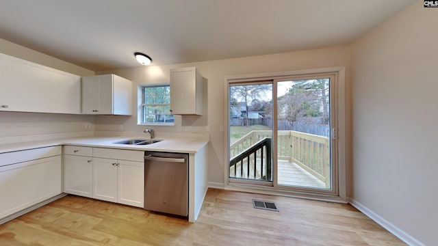 kitchen with dishwasher, light hardwood / wood-style floors, white cabinetry, and a healthy amount of sunlight