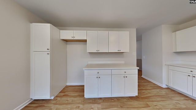 kitchen featuring white cabinets and light wood-type flooring