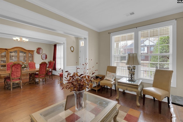 interior space with wood-type flooring, crown molding, and a chandelier