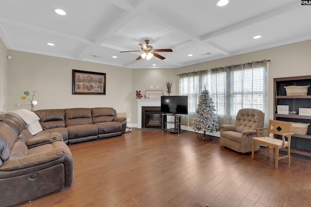 living room with wood-type flooring, ceiling fan, coffered ceiling, and beam ceiling