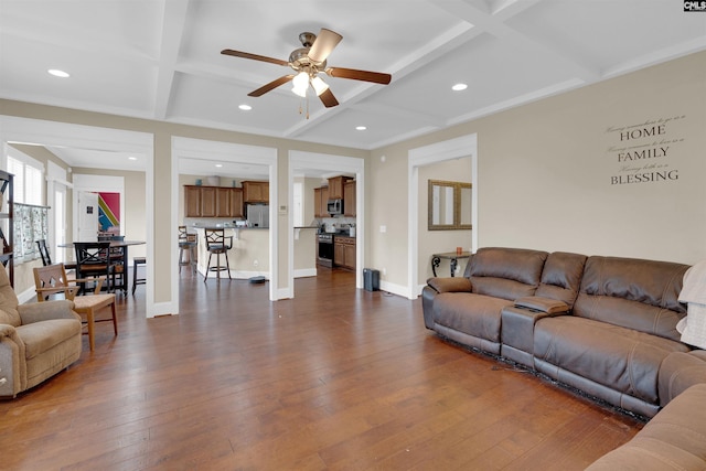 living room with ceiling fan, beam ceiling, dark wood-type flooring, and coffered ceiling