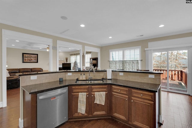 kitchen with dishwasher, dark hardwood / wood-style floors, a kitchen island with sink, and sink