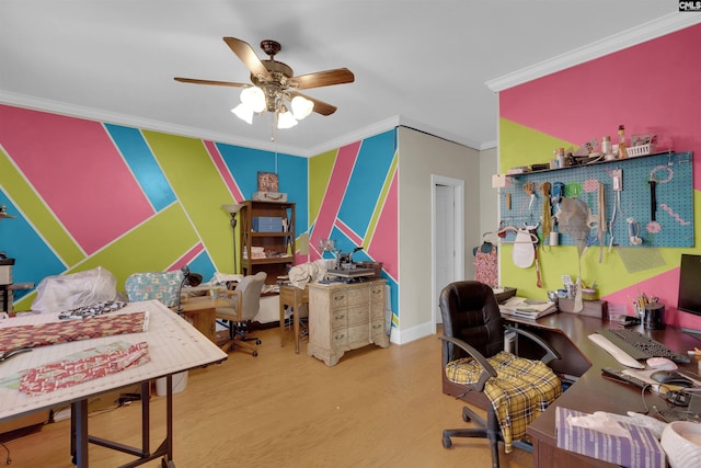 home office with ceiling fan, wood-type flooring, and crown molding