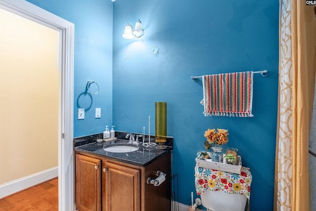 bathroom featuring hardwood / wood-style floors, vanity, and toilet